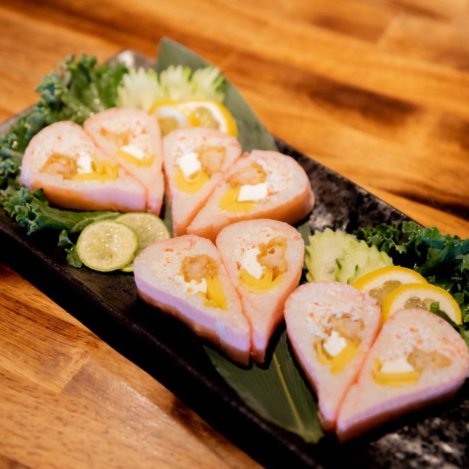 Heart-shaped Miso sushi rolls with shrimp, cream cheese, and yellow pepper, garnished with lemon and lime.